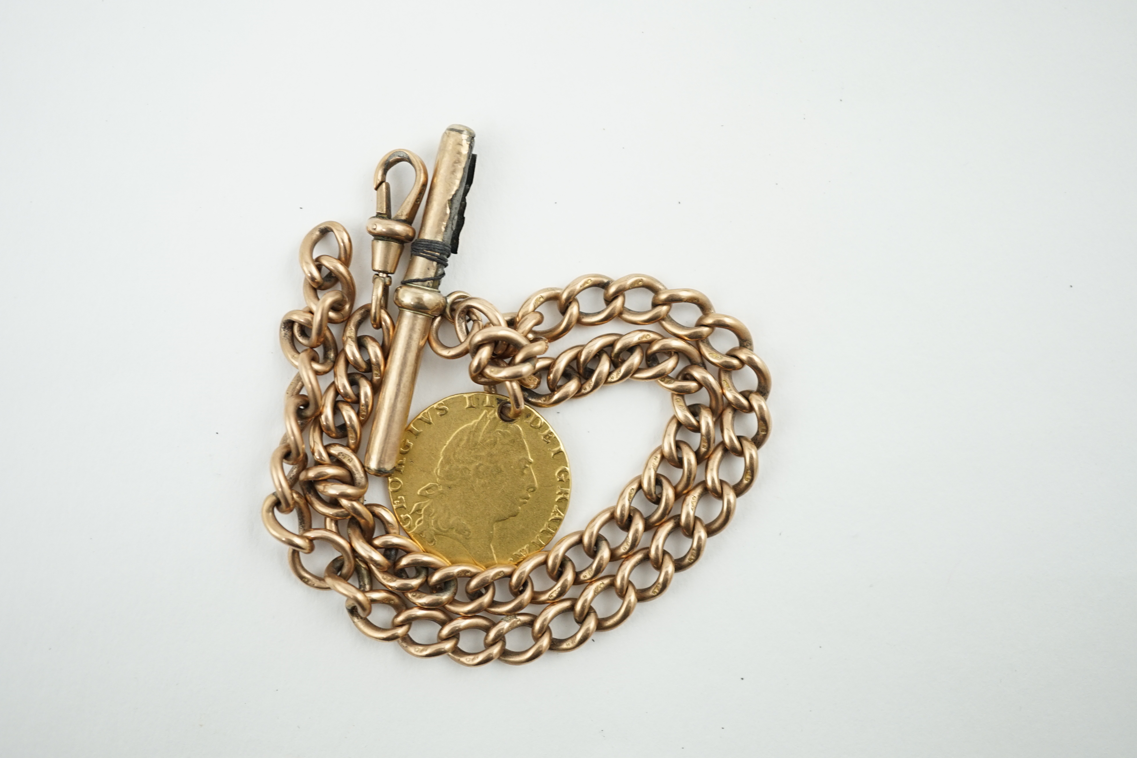 A 9ct gold albert, with gold plated T-bar and hung with a George III 1794 gold spade guinea